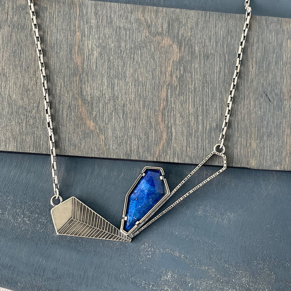 Handmade necklace in Oxidized Sterling Silver and Lapis Lazuli. Statement pieces like this one are some of my favorites to make. The play on form and surface as well as the challenge of fitting the individual components together like geometric puzzle pieces to create balance and asymmetry really satisfies my creativity.

0.5 oz 20" long, 3" wide x 1" tall

One of a Kind necklace by Erica Stankwytch Bailey