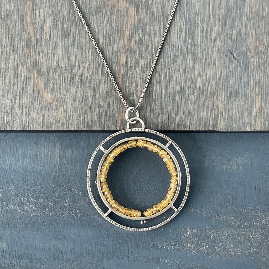 Handmade pendant using faceted yellow sapphire and oxidized sterling silver.

 0.4 oz	2"" x 1.6"" , 18 "" rounded box chain, email ericasbailey@gmail.com to request 16"".

One of a kind pendant by Erica Stankwytch Bailey